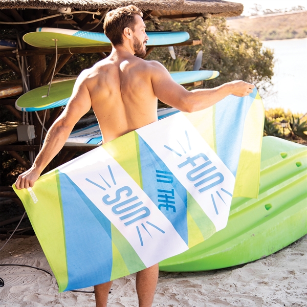 Man holding customized beach towel on beach