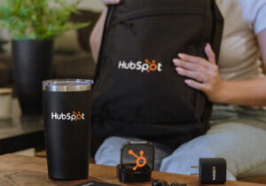 Company onboarding kit with branded backpack, branded tumbler, branded tech gifts.